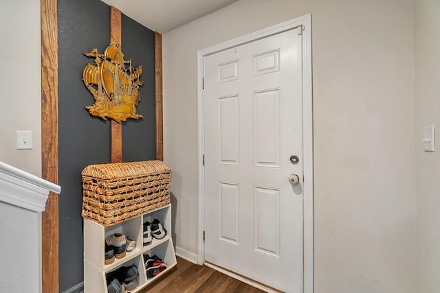 foyer entrance featuring baseboards and dark wood-style floors