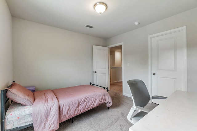 carpeted bedroom featuring visible vents and baseboards