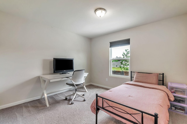bedroom with carpet flooring and baseboards