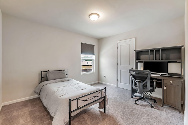 bedroom with carpet flooring and baseboards