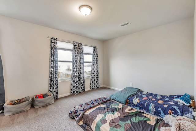carpeted bedroom with baseboards and visible vents