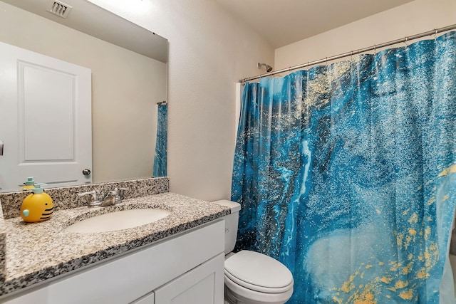 bathroom with visible vents, curtained shower, toilet, and vanity