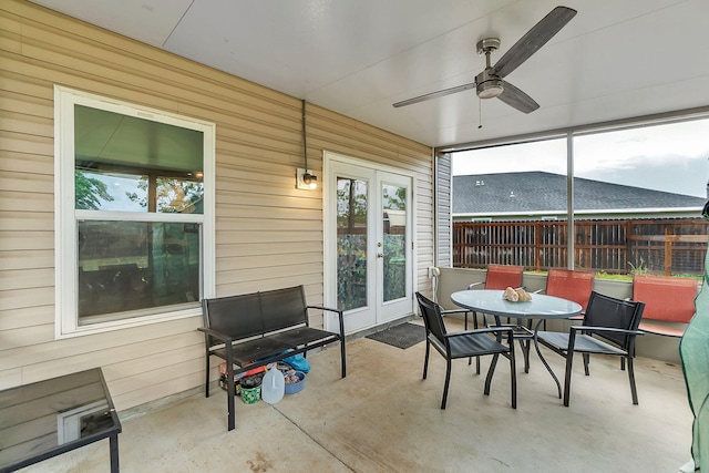 sunroom featuring french doors, a ceiling fan, and a healthy amount of sunlight