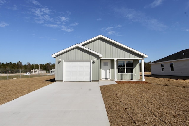 view of front facade featuring a porch, board and batten siding, concrete driveway, and a garage