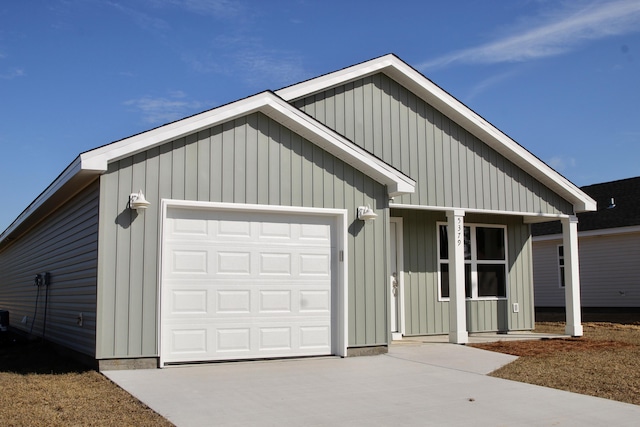 view of front of house featuring concrete driveway, an attached garage, and a porch