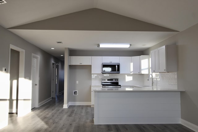 kitchen with decorative backsplash, white cabinetry, a sink, light wood finished floors, and stainless steel appliances