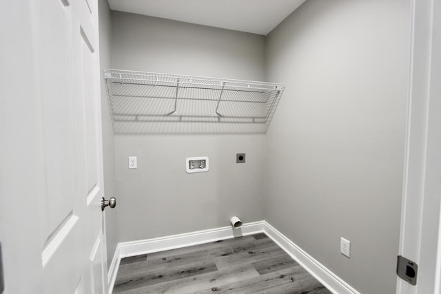 laundry area featuring laundry area, hookup for a washing machine, baseboards, electric dryer hookup, and wood finished floors