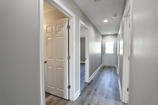 hall with recessed lighting, baseboards, and light wood-style flooring