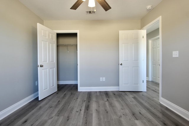 unfurnished bedroom with visible vents, baseboards, and wood finished floors