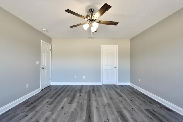 unfurnished room featuring baseboards, a ceiling fan, and wood finished floors