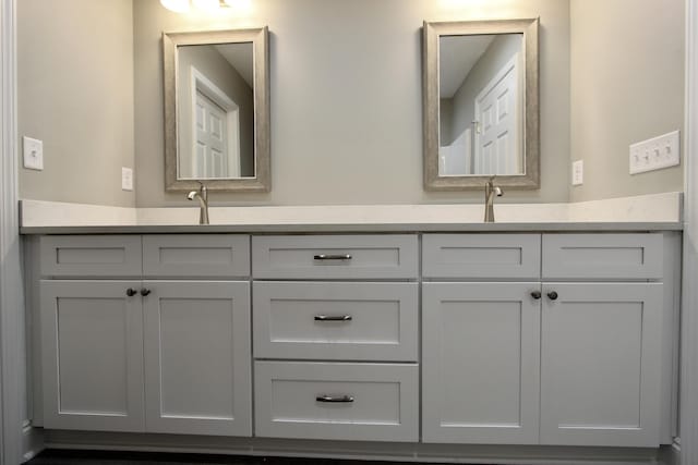 bathroom featuring double vanity and a sink