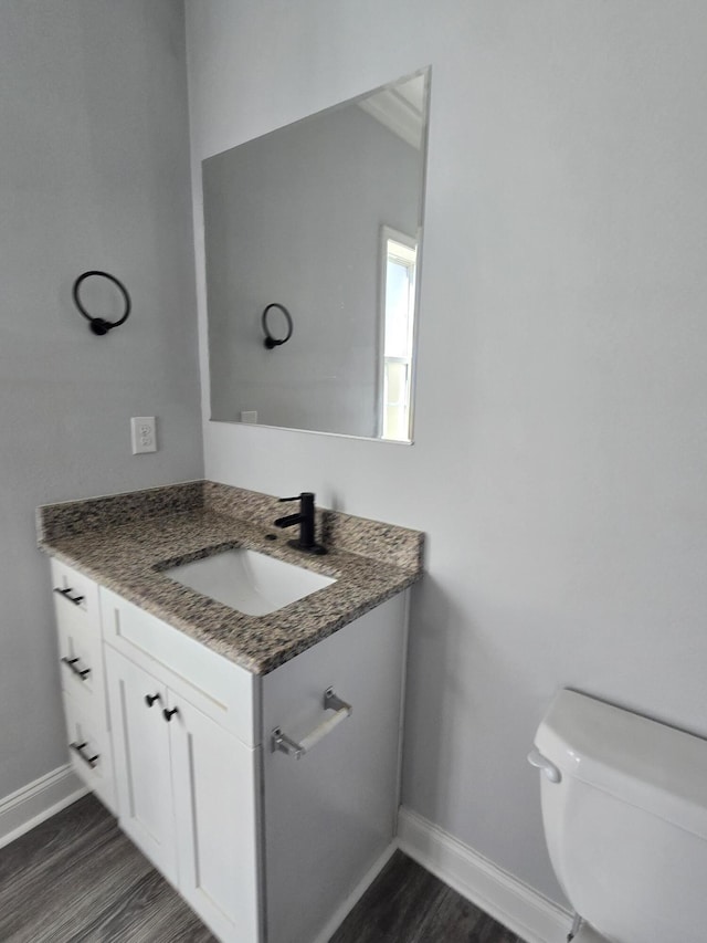 467 N County Highway 395, Santa Rosa Beach, FL 32459 - half bathroom featuring baseboards, wood finished floors, toilet, and vanity