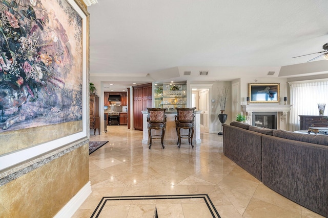 240 Gulf Shore Dr Unit 433, Destin, FL 32541 - living room with a glass covered fireplace, ceiling fan, inlaid floor details, and baseboards