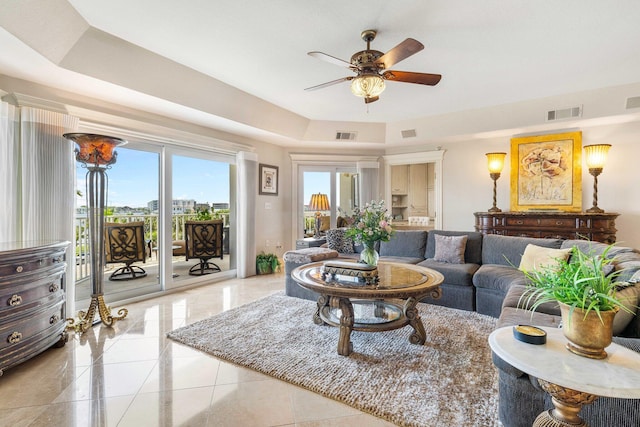 240 Gulf Shore Dr Unit 433, Destin, FL 32541 - living room featuring a ceiling fan, a tray ceiling, and light tile patterned flooring