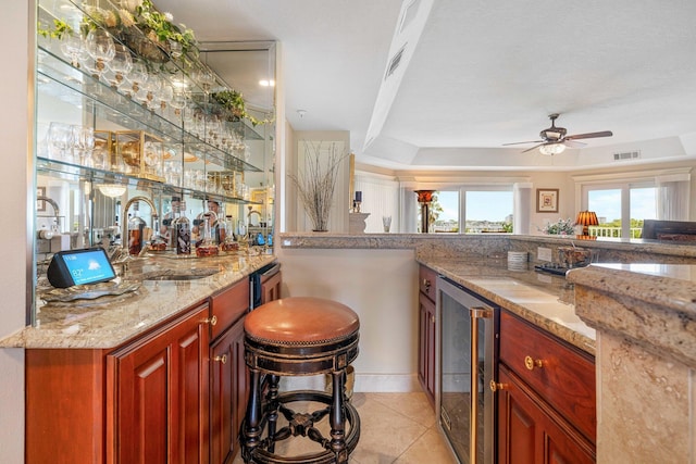 240 Gulf Shore Dr Unit 433, Destin, FL 32541 - indoor wet bar with beverage cooler, ceiling fan, light tile patterned floors, and a tray ceiling