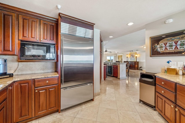 240 Gulf Shore Dr Unit 433, Destin, FL 32541 - kitchen featuring built in appliances, wine cooler, backsplash, light stone counters, and recessed lighting