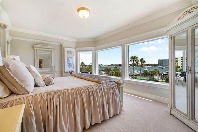 240 Gulf Shore Dr Unit 433, Destin, FL 32541 - bedroom featuring light carpet, baseboards, ornamental molding, and a water view