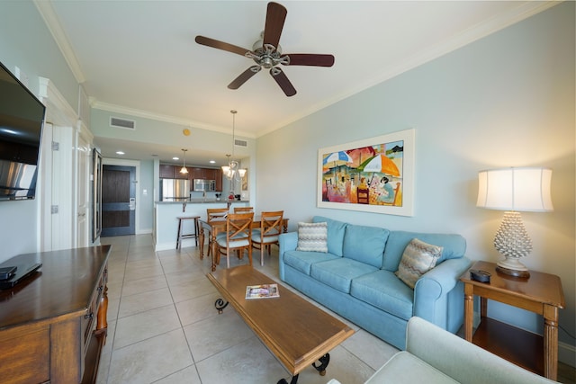 living area with crown molding, light tile patterned floors, ceiling fan, and visible vents