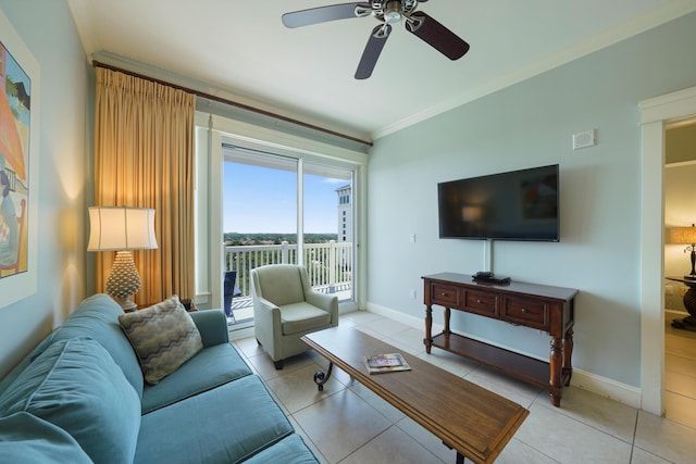 living area with baseboards, ornamental molding, ceiling fan, and light tile patterned floors