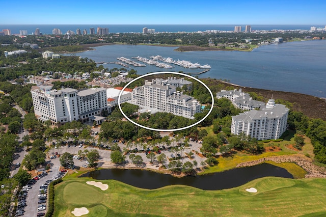 bird's eye view featuring a water view, view of golf course, and a view of city