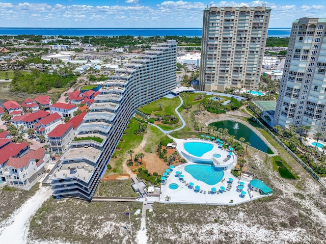 view of urban area featuring a pool area and a nearby body of water