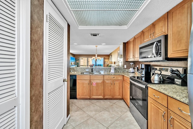 kitchen featuring appliances with stainless steel finishes, a chandelier, light tile patterned flooring, a sink, and light stone countertops