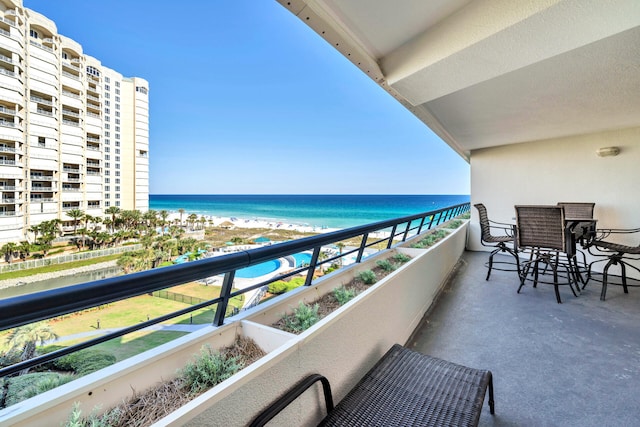 balcony featuring view of water and beach