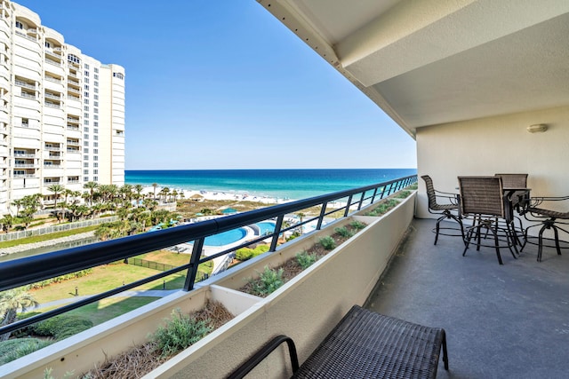balcony with view of water and beach