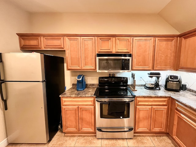 829 Fairview Dr Unit 1, Fort Walton Beach, FL 32548 - kitchen with appliances with stainless steel finishes and vaulted ceiling