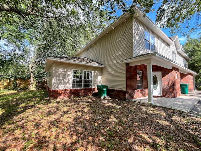 829 Fairview Dr Unit 1, Fort Walton Beach, FL 32548 - view of front facade featuring brick siding and a patio