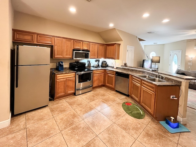 829 Fairview Dr Unit 1, Fort Walton Beach, FL 32548 - kitchen with stainless steel appliances, a peninsula, a sink, brown cabinetry, and recessed lighting