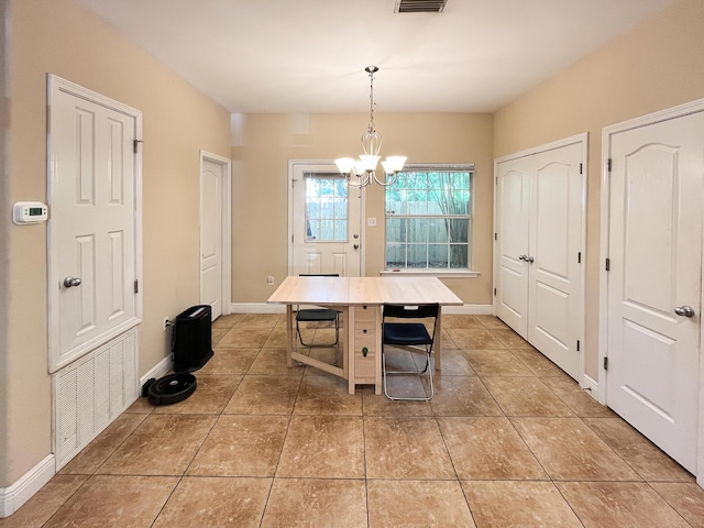 829 Fairview Dr Unit 1, Fort Walton Beach, FL 32548 - dining area featuring a chandelier, light tile patterned floors, and baseboards