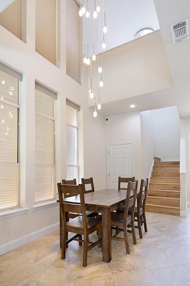 674 Emerald Bay Dr, Destin, FL 32541 - dining area with stairway, baseboards, and a high ceiling