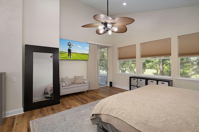 674 Emerald Bay Dr, Destin, FL 32541 - bedroom featuring wood finished floors, access to outside, baseboards, a high ceiling, and recessed lighting