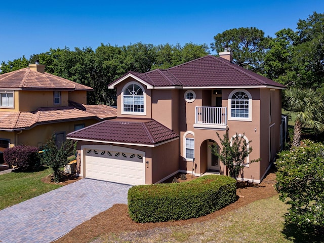 674 Emerald Bay Dr, Destin, FL 32541 - mediterranean / spanish-style home with a balcony, stucco siding, a chimney, and driveway