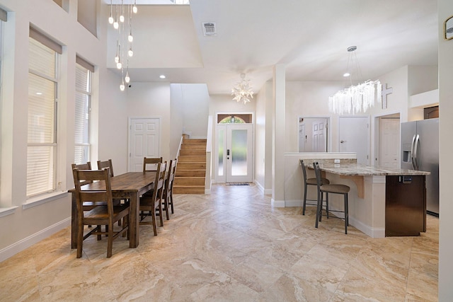 674 Emerald Bay Dr, Destin, FL 32541 - dining room with a chandelier, baseboards, a towering ceiling, and elevator