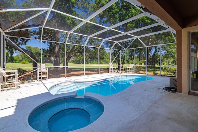 674 Emerald Bay Dr, Destin, FL 32541 - view of swimming pool with a patio area, a pool with connected hot tub, view of wooded area, and glass enclosure