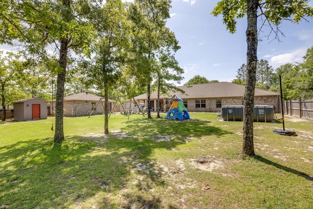 6444 Welannee Blvd, Laurel Hill, FL 32567 - view of yard featuring a playground, a shed, a swimming pool, and an outbuilding