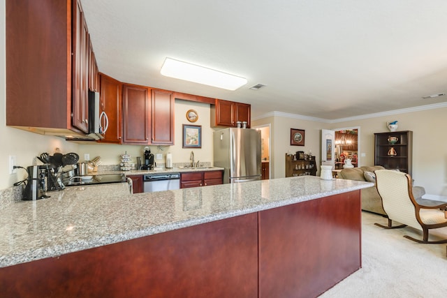 6444 Welannee Blvd, Laurel Hill, FL 32567 - kitchen with stainless steel appliances, reddish brown cabinets, a sink, a peninsula, and light carpet