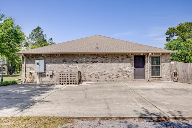 6444 Welannee Blvd, Laurel Hill, FL 32567 - view of side of property featuring brick siding, fence, roof with shingles, and a patio area