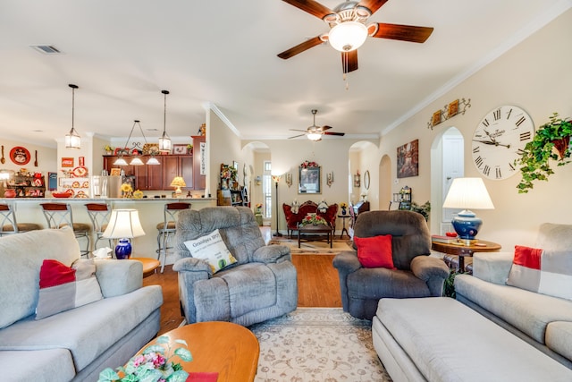 6444 Welannee Blvd, Laurel Hill, FL 32567 - living room featuring arched walkways, a ceiling fan, ornamental molding, and light wood finished floors