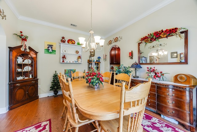 6444 Welannee Blvd, Laurel Hill, FL 32567 - dining area featuring a chandelier, crown molding, wood finished floors, and baseboards