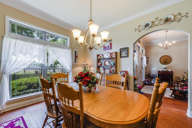 6444 Welannee Blvd, Laurel Hill, FL 32567 - dining space featuring ornamental molding, arched walkways, a chandelier, and wood finished floors
