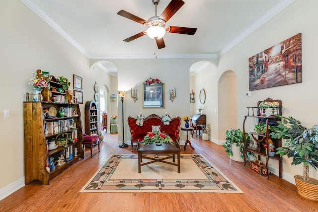 6444 Welannee Blvd, Laurel Hill, FL 32567 - living area featuring arched walkways, ceiling fan, crown molding, wood finished floors, and baseboards