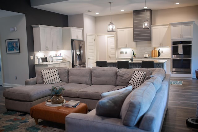 living room with recessed lighting, baseboards, and dark wood-style floors
