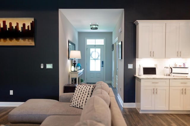 interior space with baseboards and dark wood-style floors