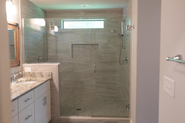 full bathroom featuring vanity and a stall shower
