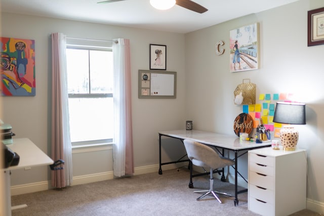 carpeted home office with a ceiling fan, baseboards, and a wealth of natural light