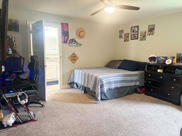 bedroom with ceiling fan, ensuite bathroom, and carpet