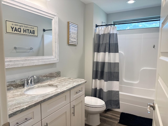full bathroom with vanity, wood finished floors, shower / bath combination with curtain, toilet, and recessed lighting